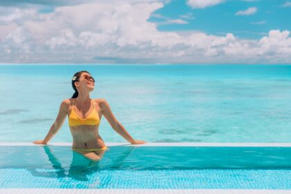 woman relaxing in an infinity pool in gorgeous caribbean destination