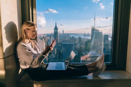 Woman Working on Laptop in Front of Empire State Building NYC