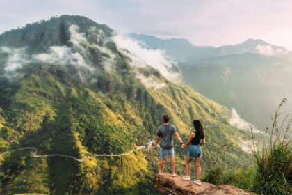 young traveler couple looking at misty mountains in sri lanka during sunrise