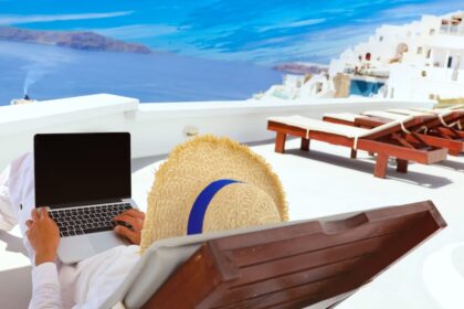 Digital nomad on laptop in Santorini, Greece
