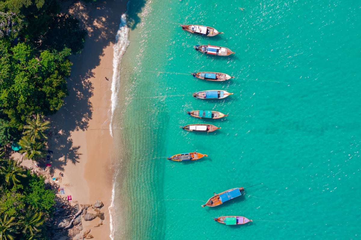 Banner Travel photo Thailand. Aerial view turquoise water, tropical beach Phuket with longtail boat.
