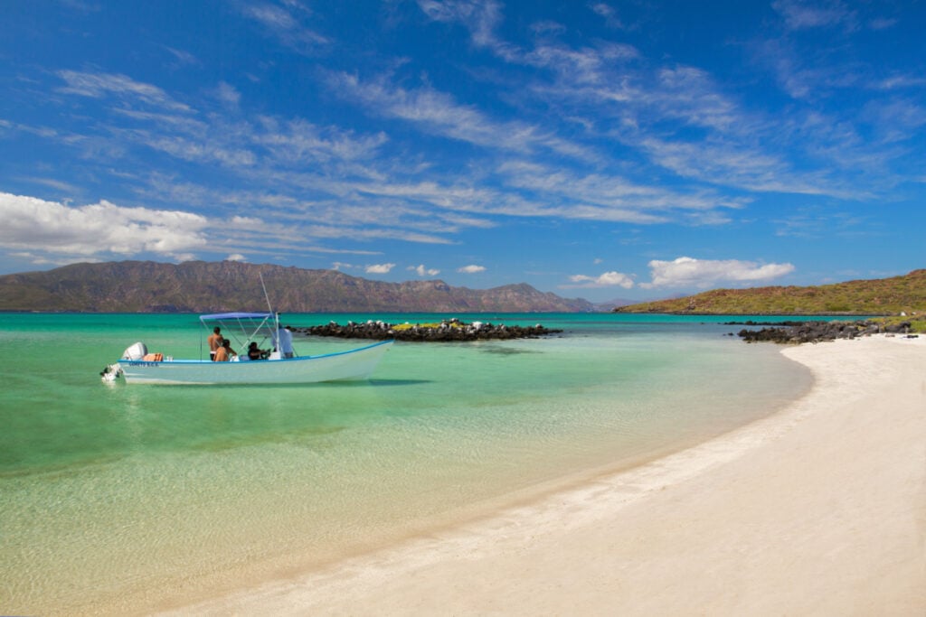 A boat in the turquoise waters of Coronado Beach in Loreto, Baja California Sur