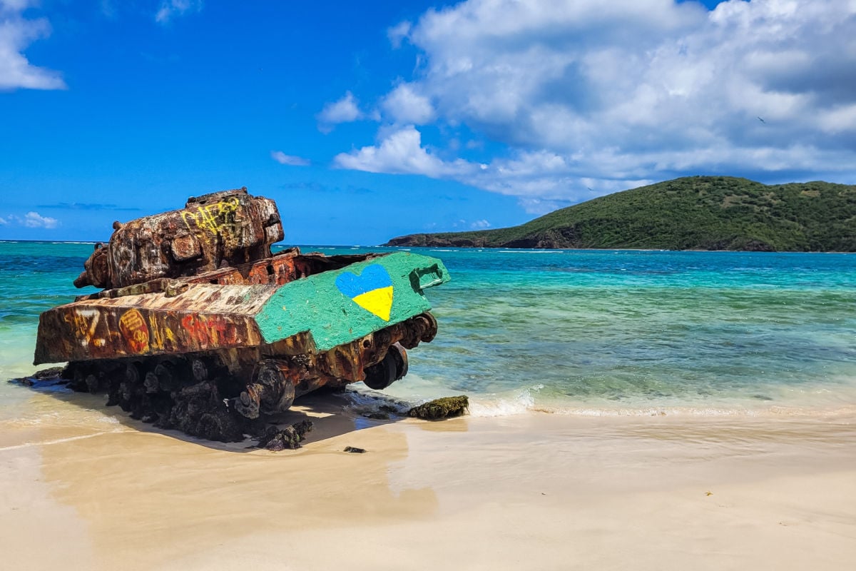 Old rusted and painted remnants of an US army tank on the Flamenco beach, Culebra Island, Puerto Rico
