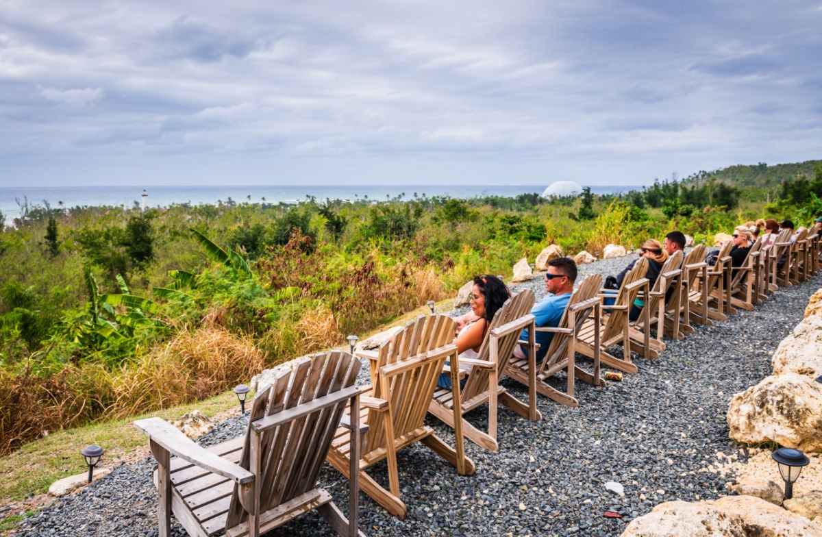 Row of Adirondack chairs set up for watching sunsets in Rincon, Puerto Rico