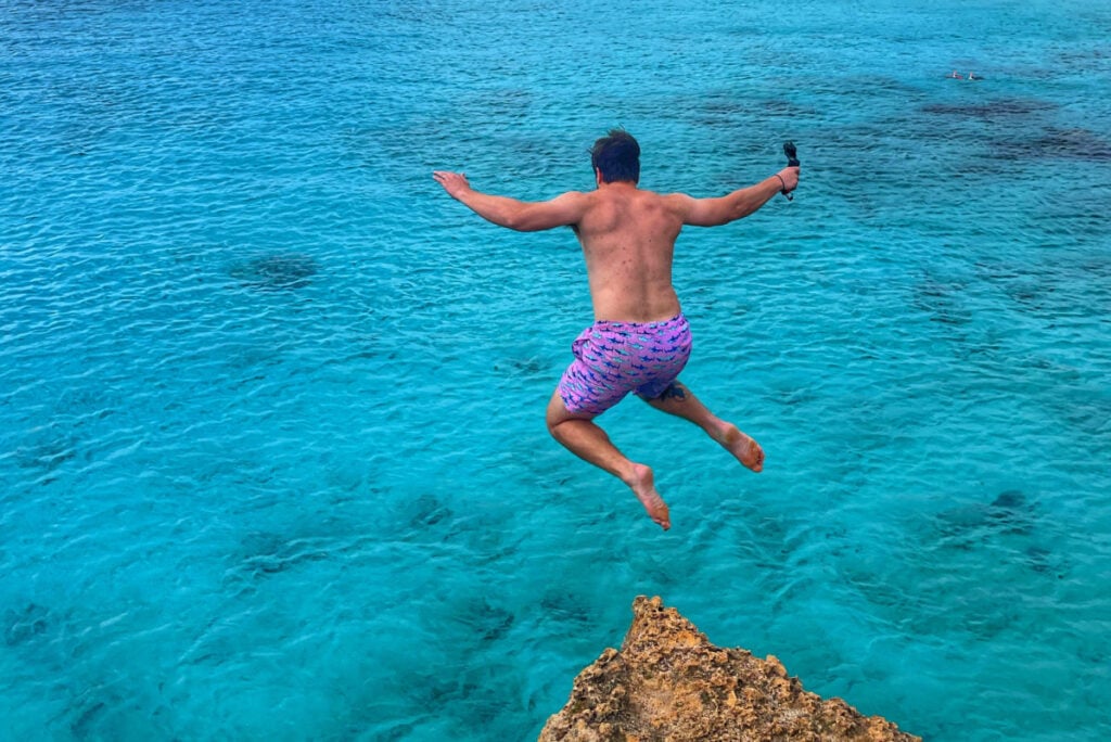 Tyler Fox jumping off a cliff at Boca Slagbaai in Bonaire
