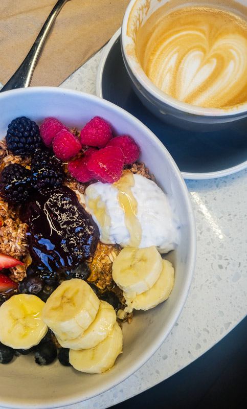 granola bowl and coffee on table