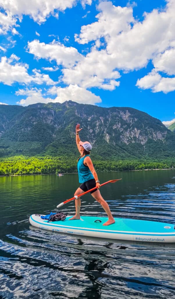 woman doing yoga on paddleboard on lake bohinj