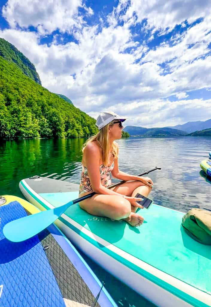 woman sitting on paddleboard lake bohinj sloenia