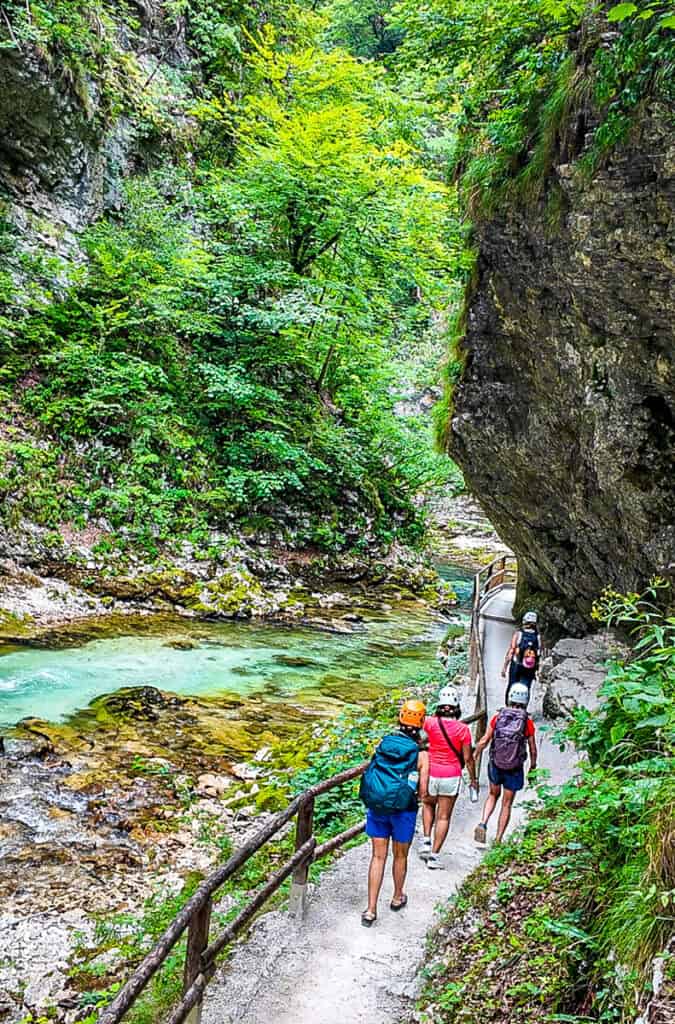 women on path through vintgar gorge