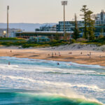 People enjoying the sand and surf at Main Beach, Wollongong.