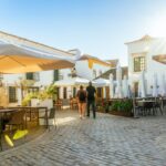 A tourist couple visiting Faro old town street
