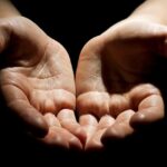 An image of open hands in generosity, a metaphor for exchanging self for others
