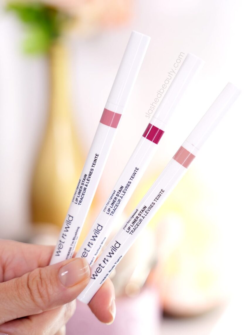 Close up of hand holding three wet n wild Perfect Pout Lip Liner Stains
