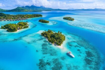 Aerial view of a tropical lagoon with turquoise water and small islands in Bora Bora, French Polynesia. featured