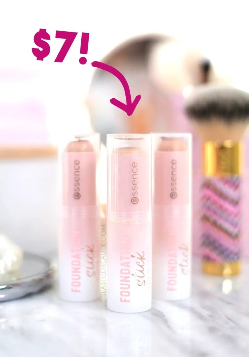 Three tubes of essence Foundation Stick standing on a vanity among brushes and mirrors. Overlaid arrow with label: $7!