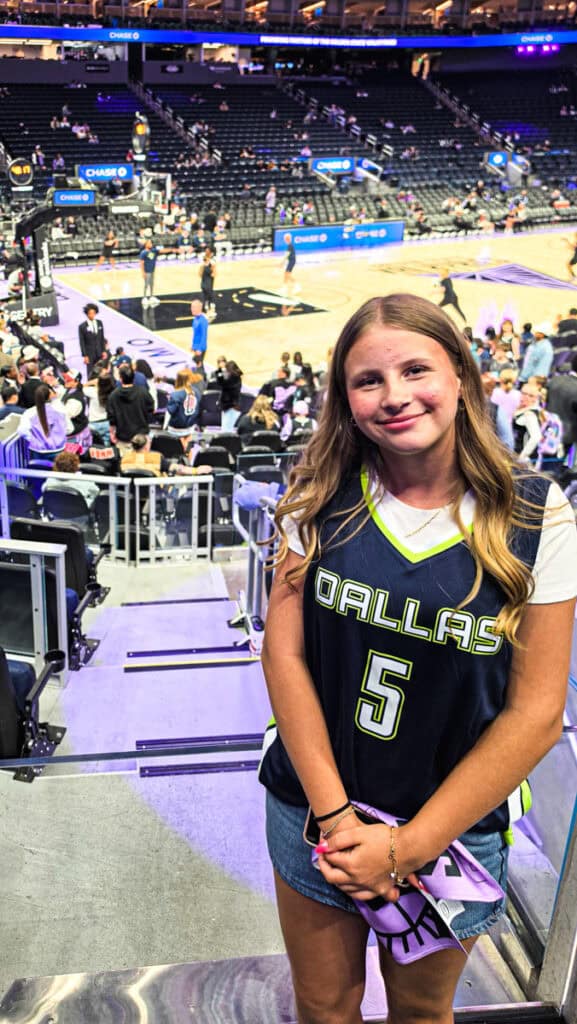 girl with dallas wings jersey on at wnba game chase center